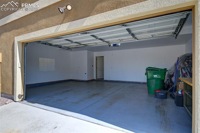 7385 Forest Meadows Ave, Colorado Springs, CO 80908 - garage featuring a garage door opener and baseboards