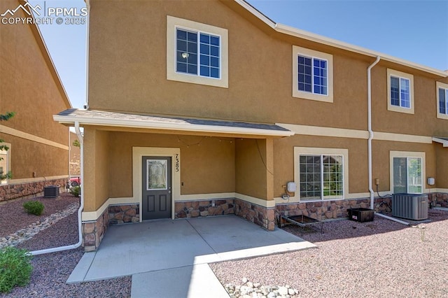 7385 Forest Meadows Ave, Colorado Springs, CO 80908 - rear view of property with stucco siding and stone siding