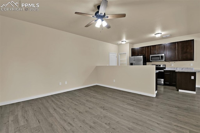 7385 Forest Meadows Ave, Colorado Springs, CO 80908 - kitchen with appliances with stainless steel finishes, ceiling fan, wood finished floors, light countertops, and open floor plan