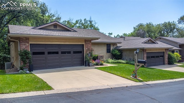 2125 Glenhill Rd, Colorado Springs, CO 80906 - ranch-style home featuring a front lawn, driveway, an attached garage, stucco siding, and roof with shingles