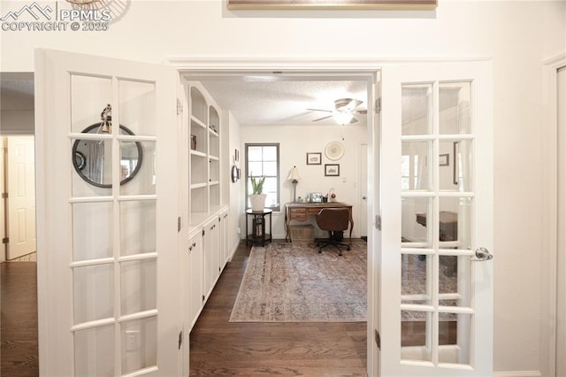 2125 Glenhill Rd, Colorado Springs, CO 80906 - hall with french doors, an office area, dark wood-type flooring, and a textured ceiling