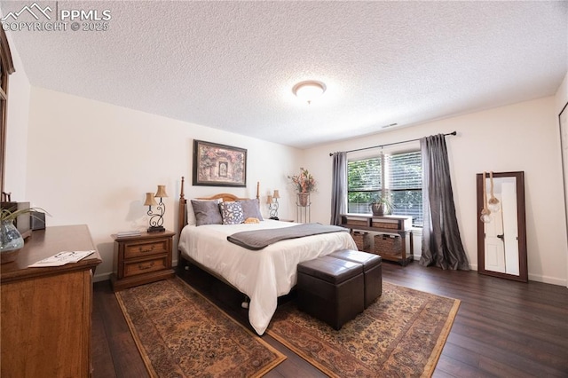2125 Glenhill Rd, Colorado Springs, CO 80906 - bedroom with dark wood finished floors and a textured ceiling