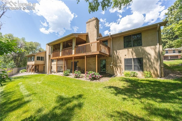 2125 Glenhill Rd, Colorado Springs, CO 80906 - rear view of house with stucco siding, a chimney, a deck, and a patio area