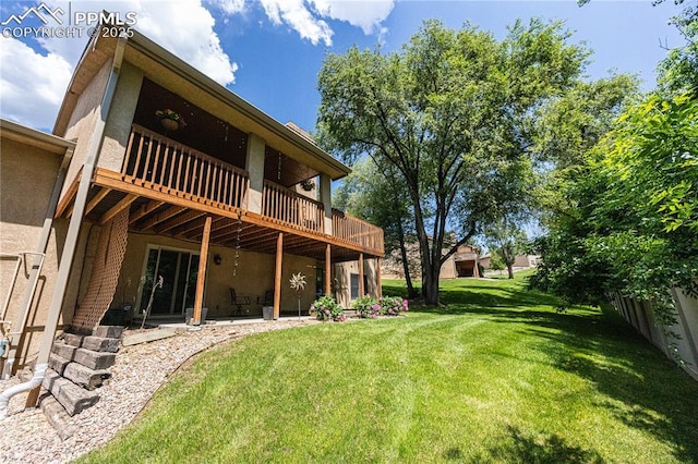 2125 Glenhill Rd, Colorado Springs, CO 80906 - rear view of house with a yard, a deck, a patio, and stucco siding
