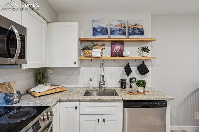 5300 E Cherry Creek Dr Unit 918, Denver, CO 80246 - kitchen featuring appliances with stainless steel finishes, open shelves, white cabinetry, and decorative backsplash