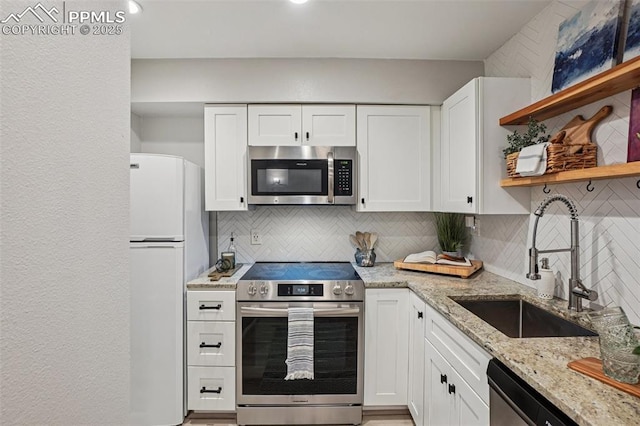 5300 E Cherry Creek Dr Unit 918, Denver, CO 80246 - kitchen with stainless steel appliances, open shelves, decorative backsplash, and white cabinets
