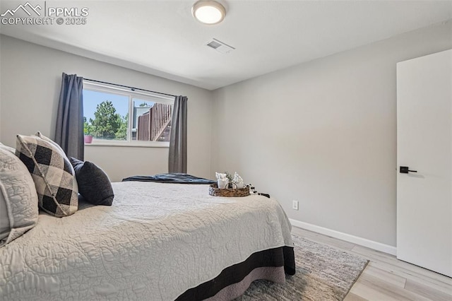 5300 E Cherry Creek Dr Unit 918, Denver, CO 80246 - bedroom with light wood-style flooring and baseboards