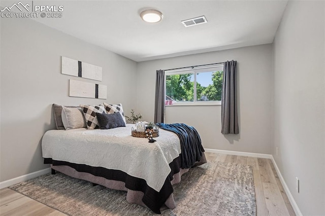 5300 E Cherry Creek Dr Unit 918, Denver, CO 80246 - bedroom featuring light wood-style floors and baseboards