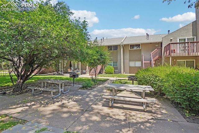 5300 E Cherry Creek Dr Unit 918, Denver, CO 80246 - view of property's community with stairs, a patio area, and a wooden deck