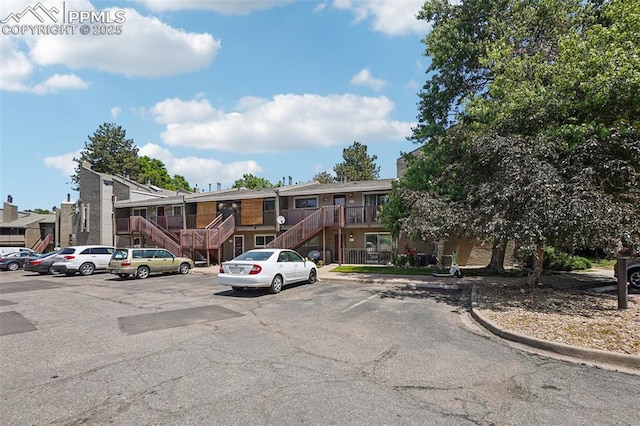 5300 E Cherry Creek Dr Unit 918, Denver, CO 80246 - view of front of house with stairs, uncovered parking, and a residential view