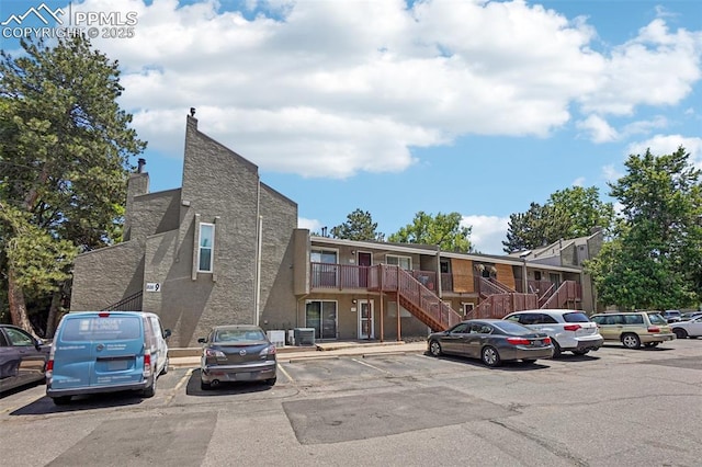 5300 E Cherry Creek Dr Unit 918, Denver, CO 80246 - view of building exterior featuring stairway and uncovered parking