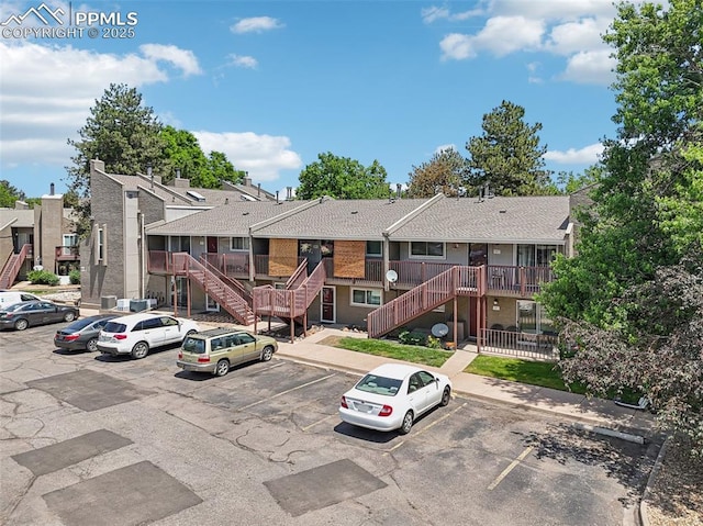 5300 E Cherry Creek Dr Unit 918, Denver, CO 80246 - view of property with stairway, uncovered parking, and a residential view