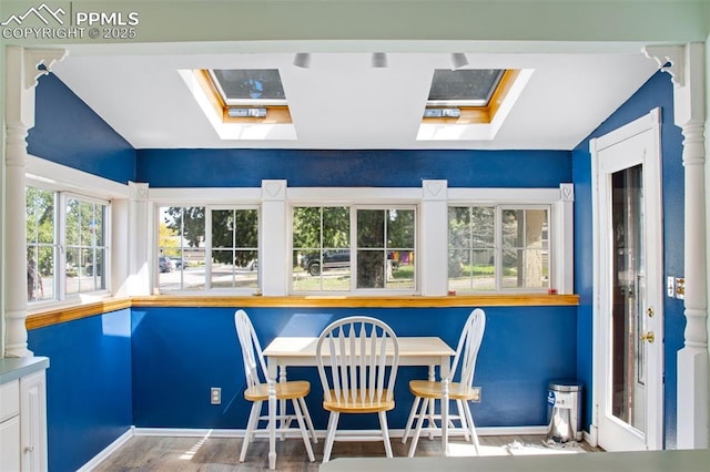 244 Washington St, Monument, CO 80132 - dining room featuring a skylight, vaulted ceiling, and wood finished floors