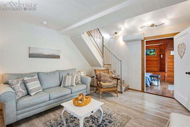 244 Washington St, Monument, CO 80132 - living area featuring a wall mounted air conditioner, light wood-style floors, stairs, and plenty of natural light