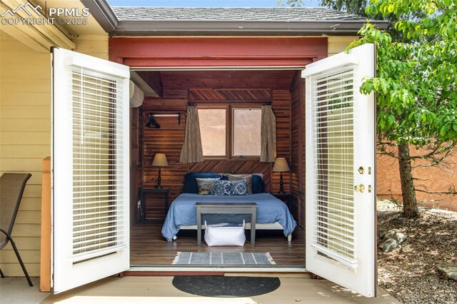 244 Washington St, Monument, CO 80132 - bedroom featuring wood finished floors and wooden walls