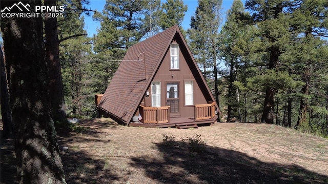 372 Crystal Dr, Cripple Creek, CO 80813 - view of home's exterior featuring a deck and roof with shingles