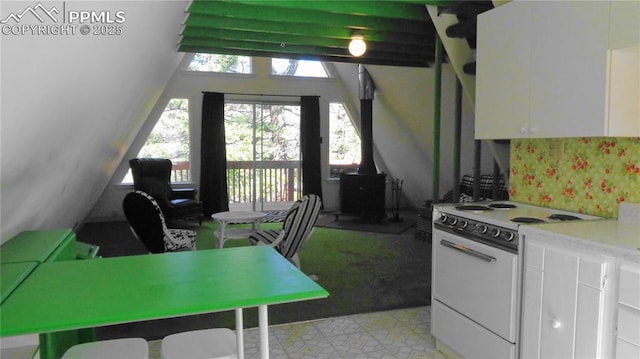 372 Crystal Dr, Cripple Creek, CO 80813 - kitchen with white range with electric cooktop, a wood stove, white cabinets, and light countertops