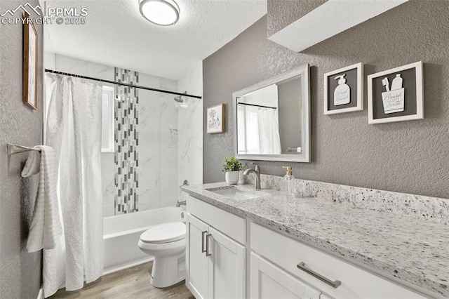 1880 Southmoor Dr, Fountain, CO 80817 - bathroom with a textured wall, vanity, wood finished floors, shower / bath combination with curtain, and a textured ceiling