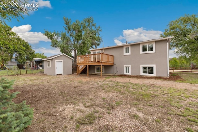 1880 Southmoor Dr, Fountain, CO 80817 - rear view of property featuring a wooden deck, a storage shed, stairs, and stucco siding