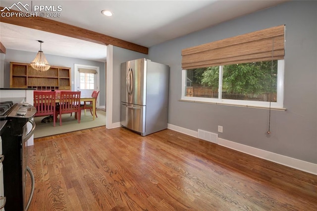 1018 Saturn Dr, Colorado Springs, CO 80905 - kitchen with stainless steel appliances, beamed ceiling, wood finished floors, decorative light fixtures, and recessed lighting