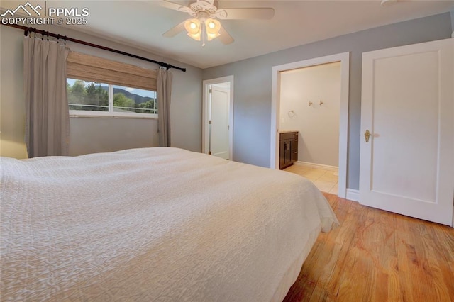 1018 Saturn Dr, Colorado Springs, CO 80905 - bedroom featuring light wood-style flooring, connected bathroom, and a ceiling fan
