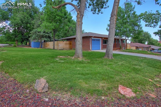 1018 Saturn Dr, Colorado Springs, CO 80905 - view of front of property with a garage, brick siding, and driveway