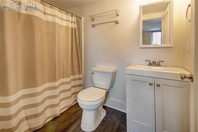 1018 Saturn Dr, Colorado Springs, CO 80905 - full bath featuring vanity, wood finished floors, and a shower with curtain