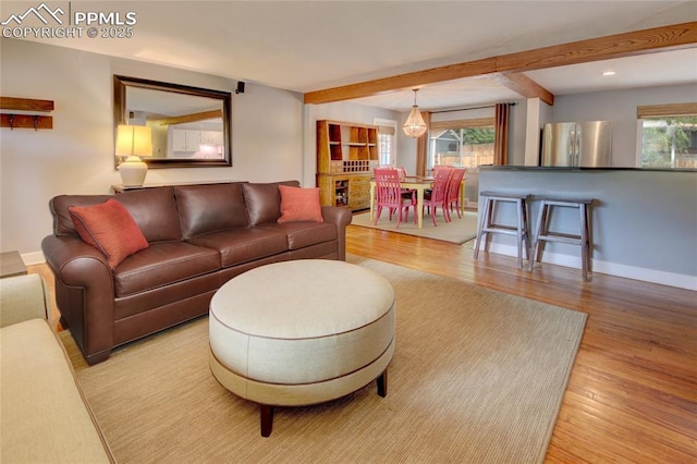1018 Saturn Dr, Colorado Springs, CO 80905 - living area featuring wood finished floors and beamed ceiling
