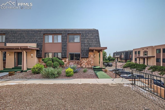 2913 Mesa Rd Unit A, Colorado Springs, CO 80904 - view of front of property featuring mansard roof and stone siding