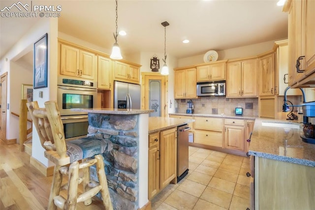 71 Crestone Cir, Florissant, CO 80816 - kitchen featuring appliances with stainless steel finishes, light brown cabinetry, tasteful backsplash, and recessed lighting