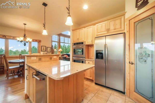 71 Crestone Cir, Florissant, CO 80816 - kitchen with appliances with stainless steel finishes, light brown cabinets, a center island, light stone counters, and a chandelier