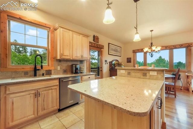 71 Crestone Cir, Florissant, CO 80816 - kitchen featuring dishwasher, light brown cabinets, a kitchen island, tasteful backsplash, and light stone counters
