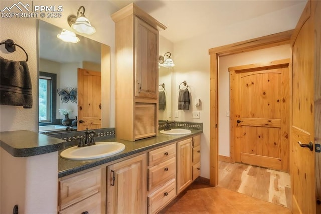 71 Crestone Cir, Florissant, CO 80816 - full bathroom featuring double vanity and wood finished floors