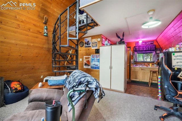 71 Crestone Cir, Florissant, CO 80816 - living room with carpet flooring, wood walls, and vaulted ceiling