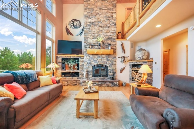 71 Crestone Cir, Florissant, CO 80816 - living area with a high ceiling, a stone fireplace, and wood finished floors