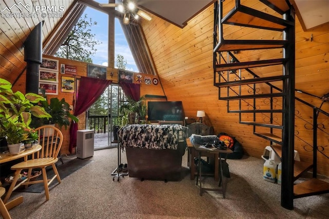 71 Crestone Cir, Florissant, CO 80816 - carpeted living area with wood walls, high vaulted ceiling, and stairs