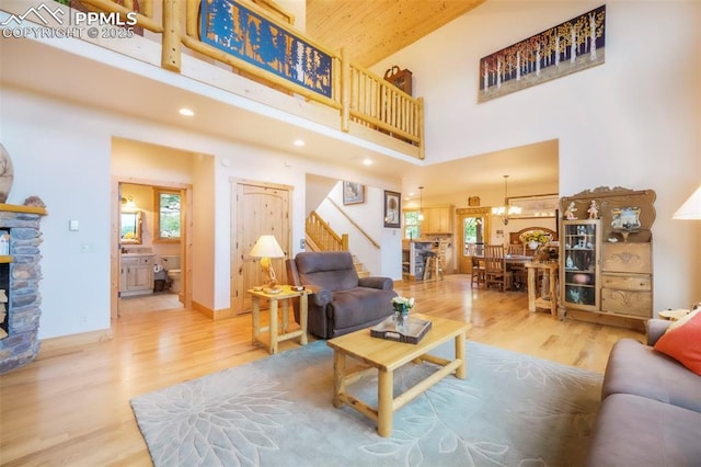 71 Crestone Cir, Florissant, CO 80816 - living area featuring stairway, a towering ceiling, wood finished floors, healthy amount of natural light, and recessed lighting