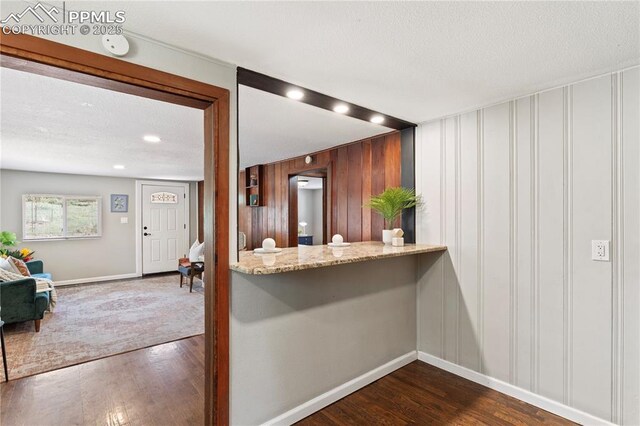 121 Via, San Miguel, Manitou Springs, CO 80829 - kitchen with dark wood-type flooring, a textured ceiling, and a decorative wall