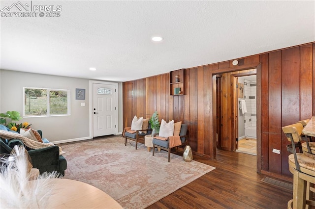 121 Via, San Miguel, Manitou Springs, CO 80829 - living area featuring wood walls, dark wood-style flooring, recessed lighting, and a textured ceiling