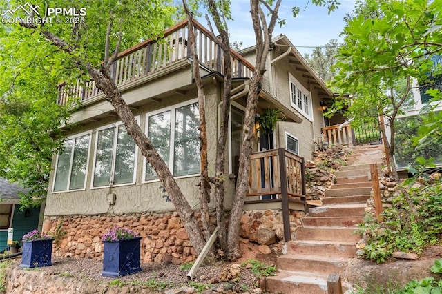 33 Minnehaha Ave, Manitou Springs, CO 80829 - view of home's exterior featuring a balcony, stairway, and a sunroom