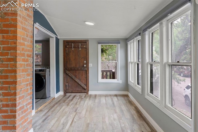 33 Minnehaha Ave, Manitou Springs, CO 80829 - unfurnished sunroom with washer / dryer, lofted ceiling, and wood finished floors