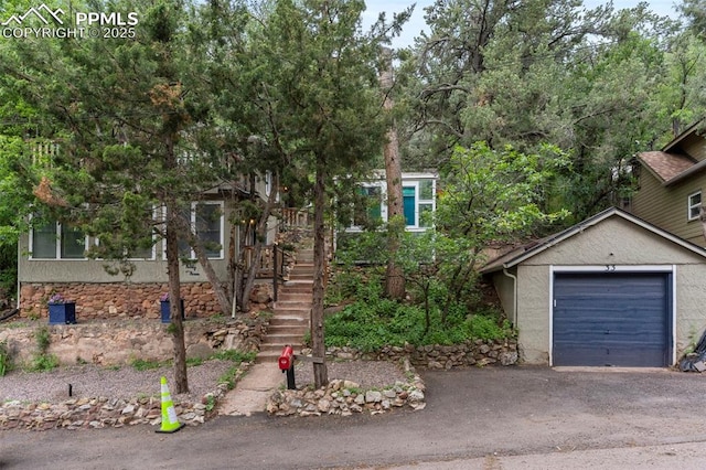33 Minnehaha Ave, Manitou Springs, CO 80829 - obstructed view of property with driveway, a garage, and stairway