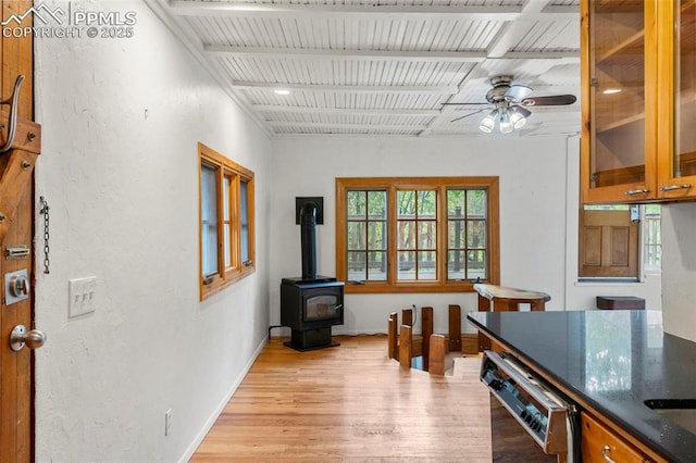 33 Minnehaha Ave, Manitou Springs, CO 80829 - dining space with light wood-type flooring, a ceiling fan, and a wood stove