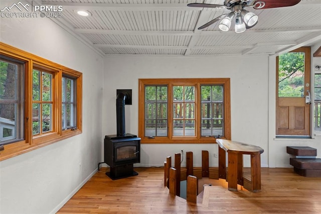 33 Minnehaha Ave, Manitou Springs, CO 80829 - unfurnished sunroom featuring plenty of natural light and a wood stove