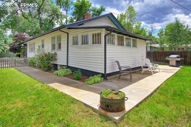 620 E Fontanero St, Colorado Springs, CO 80907 - view of side of home featuring a chimney and a patio area