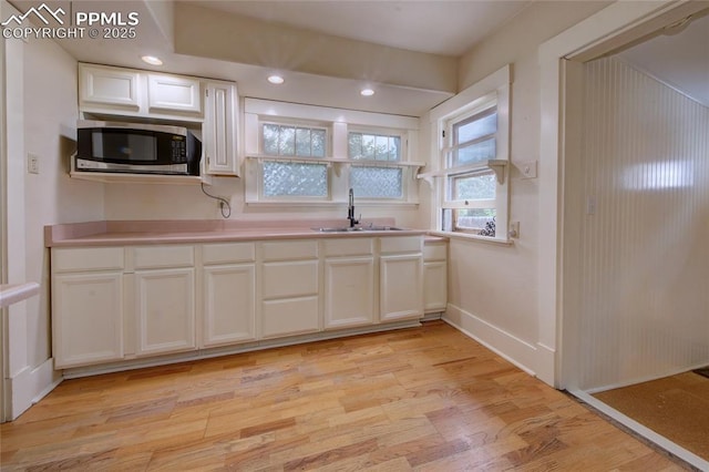 620 E Fontanero St, Colorado Springs, CO 80907 - kitchen with stainless steel microwave, light wood-style floors, white cabinetry, light countertops, and recessed lighting