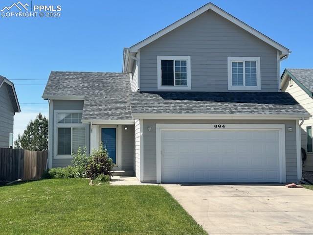 994 Turf Trail Ct, Fountain, CO 80817 - traditional-style house featuring driveway, roof with shingles, and an attached garage