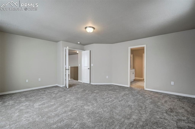 8235 Kittrick Pl, Falcon, CO 80831 - unfurnished bedroom with carpet flooring, a textured ceiling, and ensuite bathroom