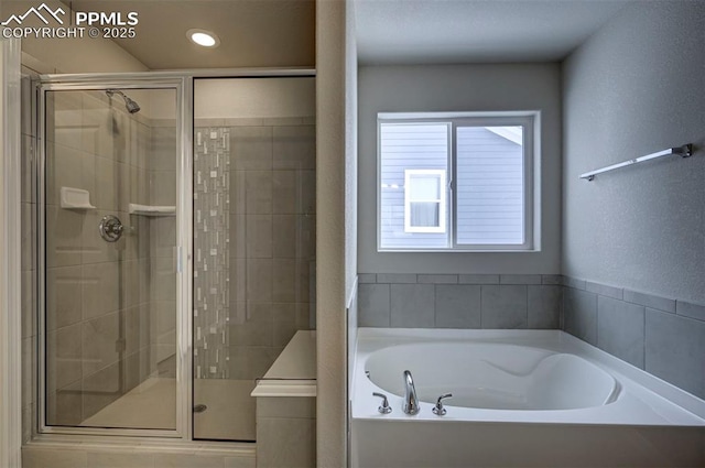 8235 Kittrick Pl, Falcon, CO 80831 - full bathroom featuring a bath, a stall shower, and recessed lighting