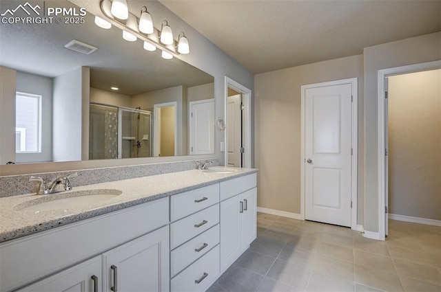 8235 Kittrick Pl, Falcon, CO 80831 - full bath featuring double vanity, a shower stall, and tile patterned flooring